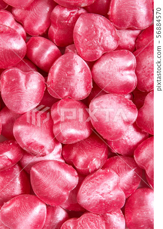 Heart shaped sucking candies as background. 56884570