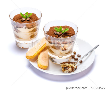 Classic tiramisu dessert in a glass cup on the plate on white background with clipping path 56884577