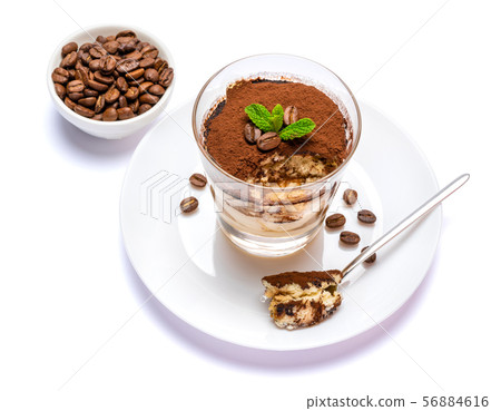 Classic tiramisu dessert in a glass cup on the plate on white background with clipping path 56884616