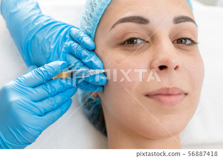The beautician makes professional rejuvenation 56887418