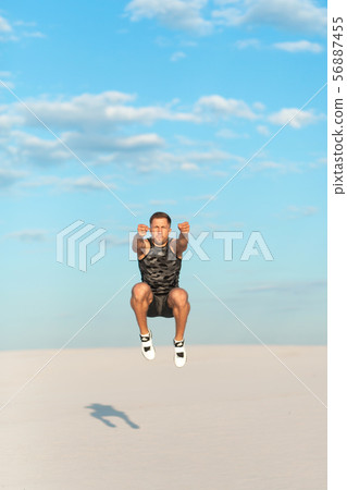 Fitness man doing exercises in sand desert. Sport Fitness man doing exercises in sand desert. Sport 56887455