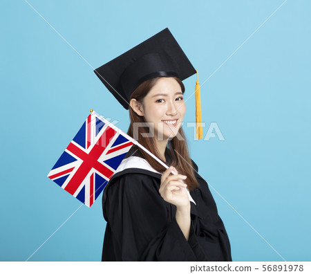 happy Young female graduation student showing the 56891978