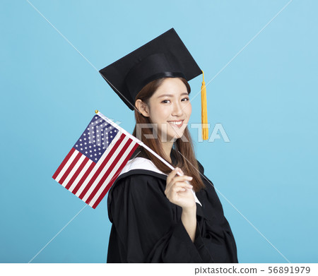 happy Young female graduation student showing the 56891979