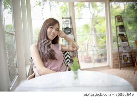 face of beautiful asian younger woman smiling with 56893649