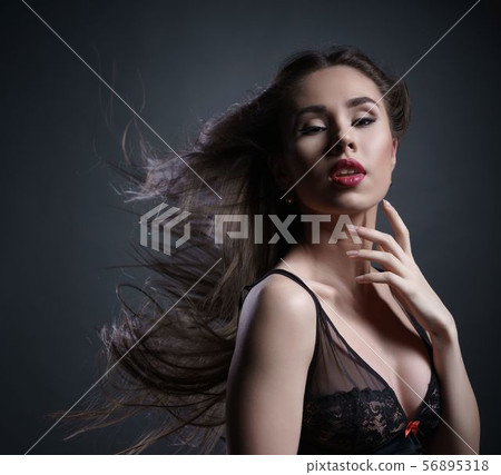 Erotica. Sensual girl posing with hair fluttering 56895318