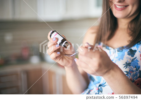 Selective focus of medicine in hands of pregnant woman 56897494