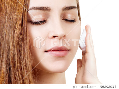 Young woman cleaning her face by napkins. Young woman cleaning her face by napkins. 56898031