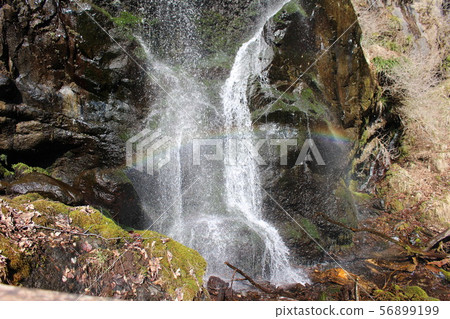Rainbow over waterfall 56899199