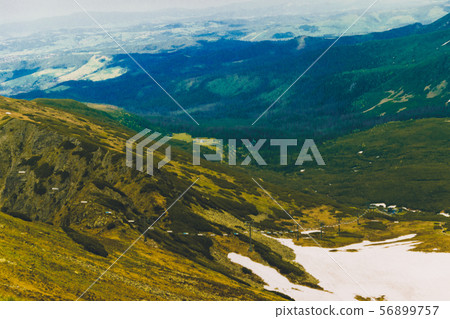 Beautiful panorama of green mountains hills with snow from Kars to Kasprowy Wierch in summer. Beautiful panorama of green mountains hills with snow from Kars to Kasprowy Wierch in summer. 56899757