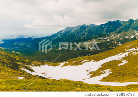 Beautiful panorama of green mountains hills with snow from Kars to Kasprowy Wierch in summer. 56899758