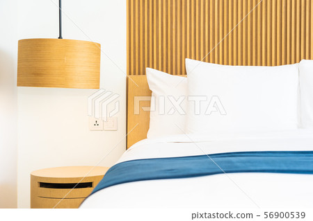 Beautiful comfortable pillow on bed decoration in bedroom 56900539