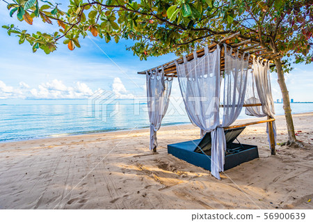 Empty bed chair and lounge on the tropical beach sea ocean with white cloud on blue sky 56900639