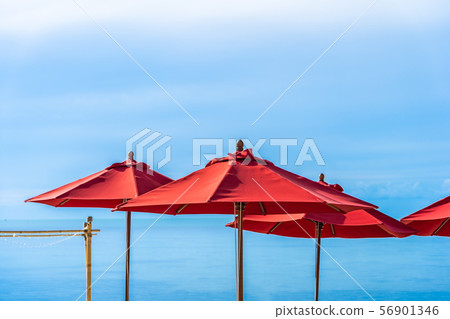 Beautiful outdoor tropical beach sea ocean with umbrella chair and lounge deck around there on white cloud blue sky Beautiful outdoor tropical beach sea ocean with umbrella chair and lounge deck around there on white cloud blue sky 56901346
