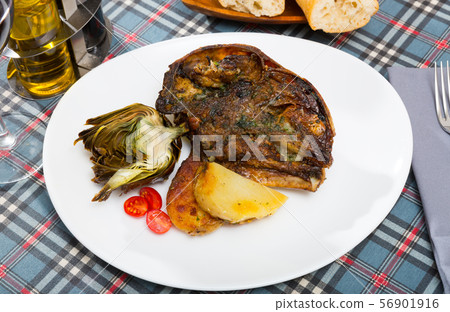 Spanish dish - lamb head with artichoke, tomatoes and potatoes 56901916