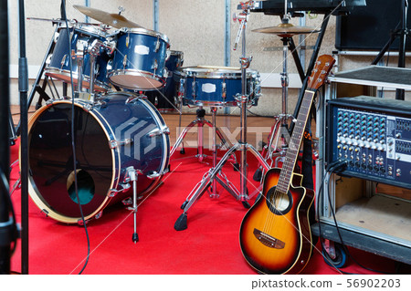 Set of musical instruments ready for rehearsal of music band in modern sound studio Set of musical instruments ready for rehearsal of music band in modern sound studio 56902203