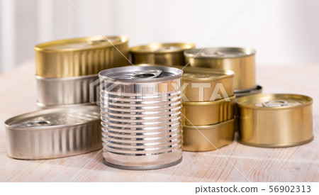 Unlabeled tin cans on table 56902313