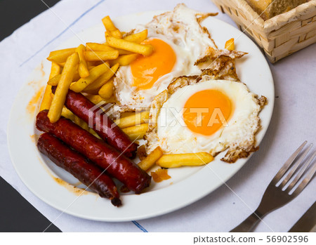 Huevos con chistorra. Scrambled eggs with sausage and potatoes. Spanish cuisine 56902596