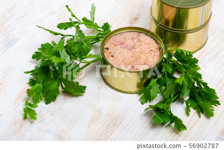 Canned tuna with parsley and lemon on a wooden table Canned tuna with parsley and lemon on a wooden table 56902787