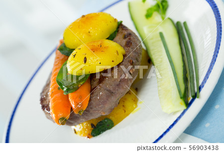Beef patty with baked vegetables 56903438