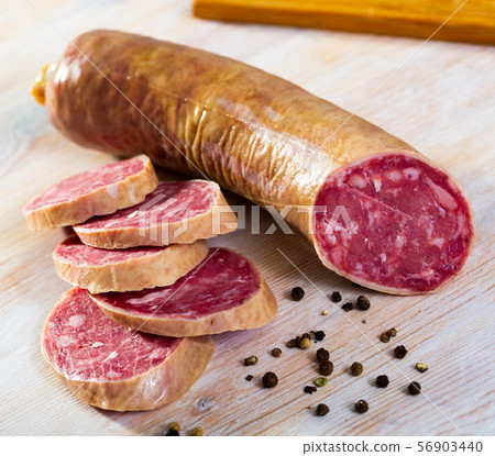 Salchichon spanish sausage slices on wooden desk 56903440