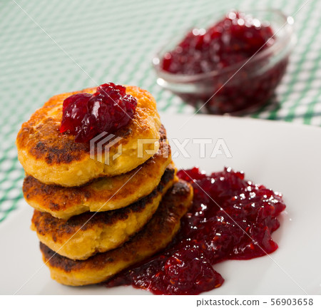 Stack of tasty fried quark pancakes served with berry jam Stack of tasty fried quark pancakes served with berry jam 56903658