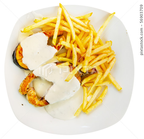 Tasty fried salmon with white sauce and french fries potatoes on plate 56903709