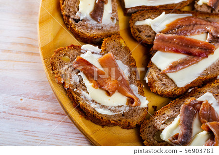 Bread with butter and salted anchovy fillets Bread with butter and salted anchovy fillets 56903781