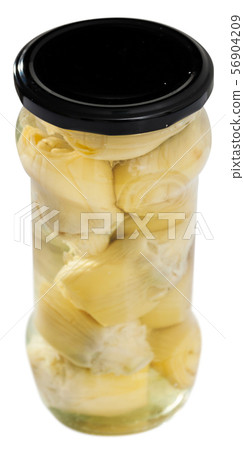 Glass jar with preserved marinated artichokes on table, nobody Glass jar with preserved marinated artichokes on table, nobody 56904209