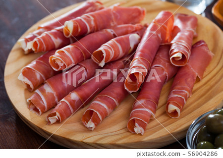 Spanish tasty meal rolls of prosciutto di parma at wooden desk 56904286