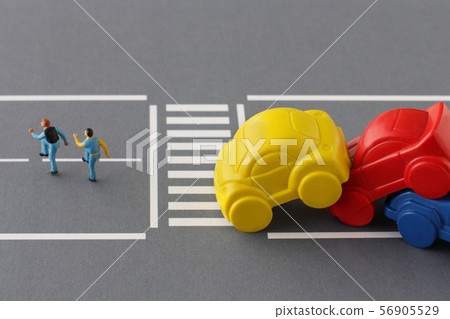 People and cars who are on the verge of an accident without obeying traffic rules and crossing the pedestrian crossing People and cars who are on the verge of an accident without obeying traffic rules and crossing the pedestrian crossing 56905529