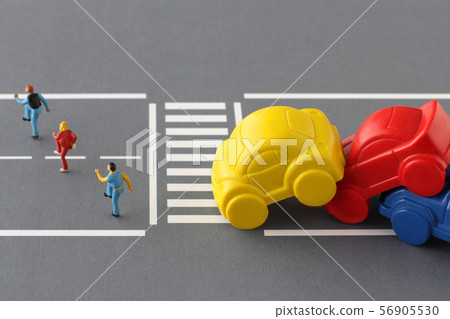 People and cars who are on the verge of an accident without obeying traffic rules and crossing the pedestrian crossing 56905530