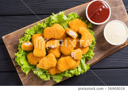 Chicken nuggets in plate on rustic background 56908016
