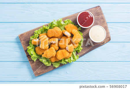 Chicken nuggets in plate on rustic background Chicken nuggets in plate on rustic background 56908017