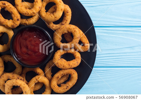 Crunchy fried onion rings and ketchup Crunchy fried onion rings and ketchup 56908067