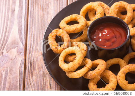 Crunchy fried onion rings and ketchup Crunchy fried onion rings and ketchup 56908068