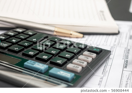 calculator and documents for working on the table, 56908444