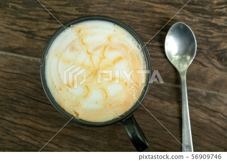 Cappuccino Coffee on the Teak Wood Table 56909746