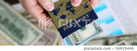 Male arms holding passport banking pack of US 56910446