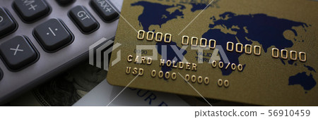 Credit card and calculator lying on big amount of US money Credit card and calculator lying on big amount of US money 56910459