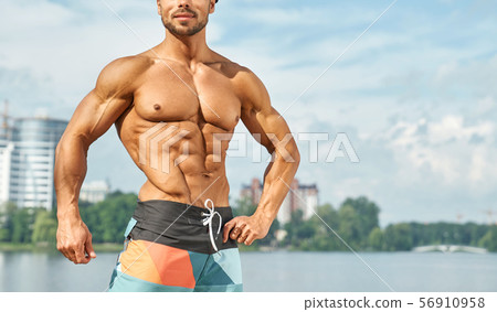 Crop of bare chest of professional male bodybuilder. 56910958