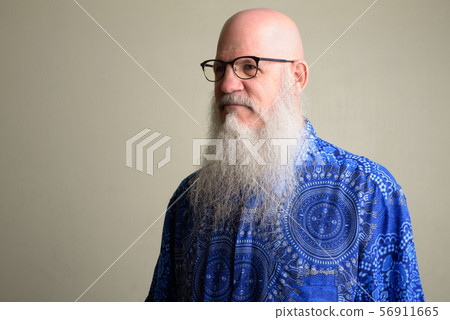 Mature bearded bald man with eyeglasses thinking Mature bearded bald man with eyeglasses thinking 56911665