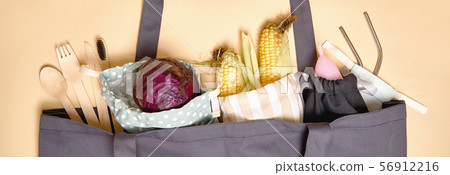 Grey shopper bag on beige background. zero waste. cutlery, toothbrush, metal straw banner 56912216