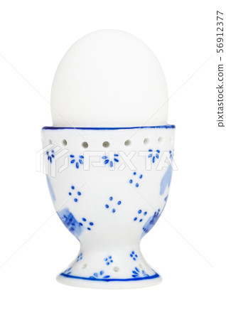 white boiled egg in egg cup with a blunt end up 56912377