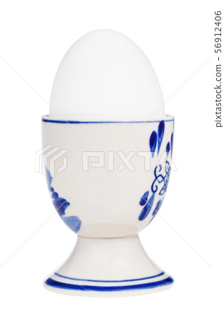 white boiled egg in cup with a pointy end up 56912406