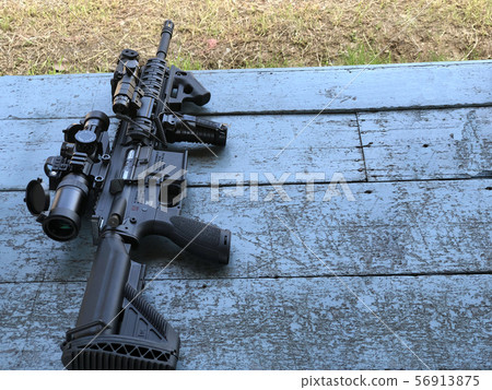 Assault rifle placed on the table 56913875