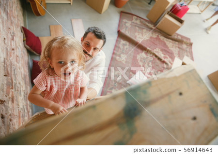 Young father and his daughter moved to a new house or apartment Young father and his daughter moved to a new house or apartment 56914643