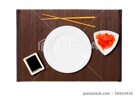 Empty round white plate with chopsticks for sushi, 56920438