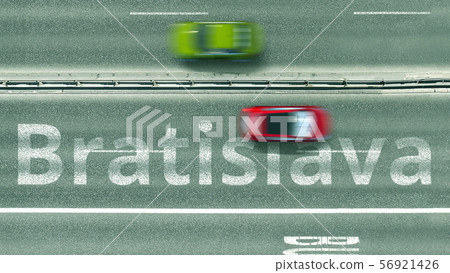 Aerial down view of the motorway with cars and Bratislava caption. Car travel to Slovakia 3D 56921426