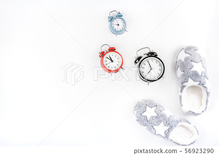 Soft fluffy slippers and alarm clocks 56923290