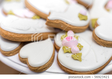 Closeup of gingerbread cookies in a white glaze. Closeup of gingerbread cookies in a white glaze. 56923421